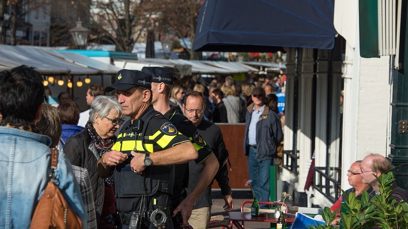Agenten surveilleren op een markt.
